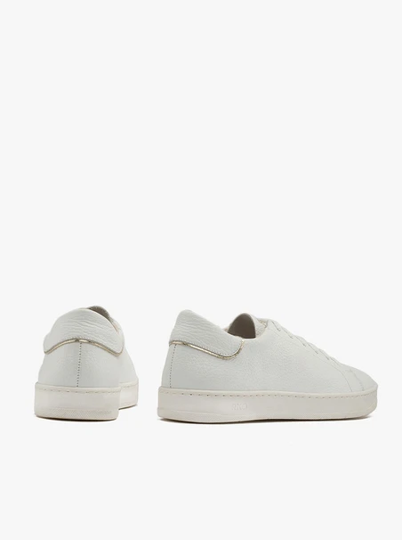 White sneakers with gold accents