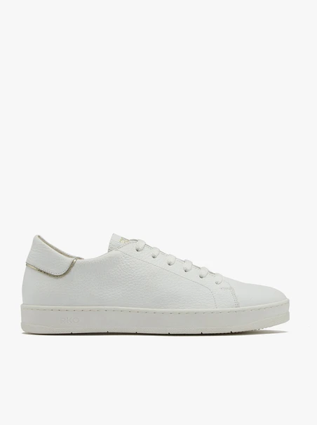 White sneakers with gold accents