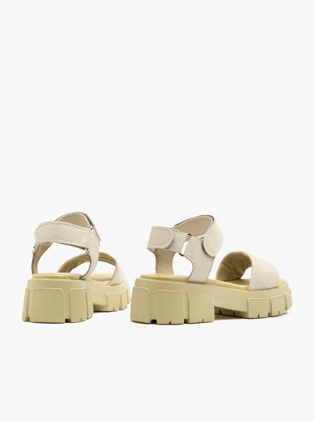 Cremefarbene Sandalen auf leichtem Grund