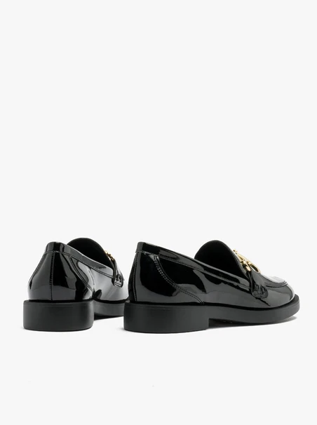 Black loafers with gold ornament