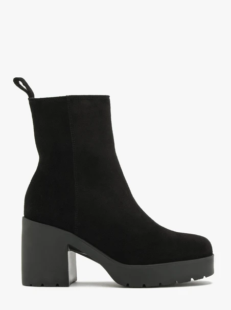 Schwarze Stiefel mit massivem Absatz, isoliert mit natürlichem Schafsfell