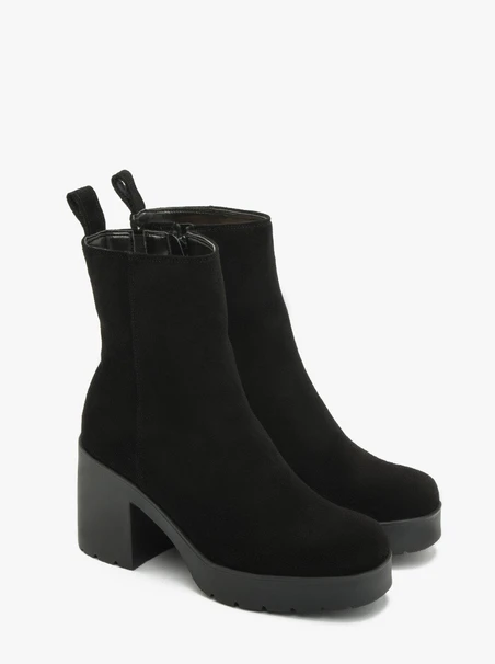 Schwarze Stiefel mit massivem Absatz, isoliert mit natürlichem Schafsfell