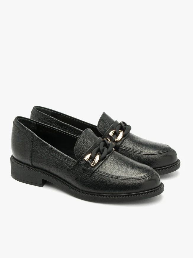 Black loafers with gold-and-black ornament