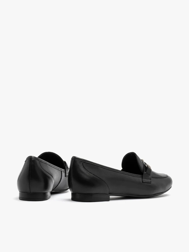Black loafers with ornament on the upper