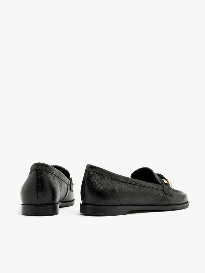 Black loafers with gold-and-black ornament