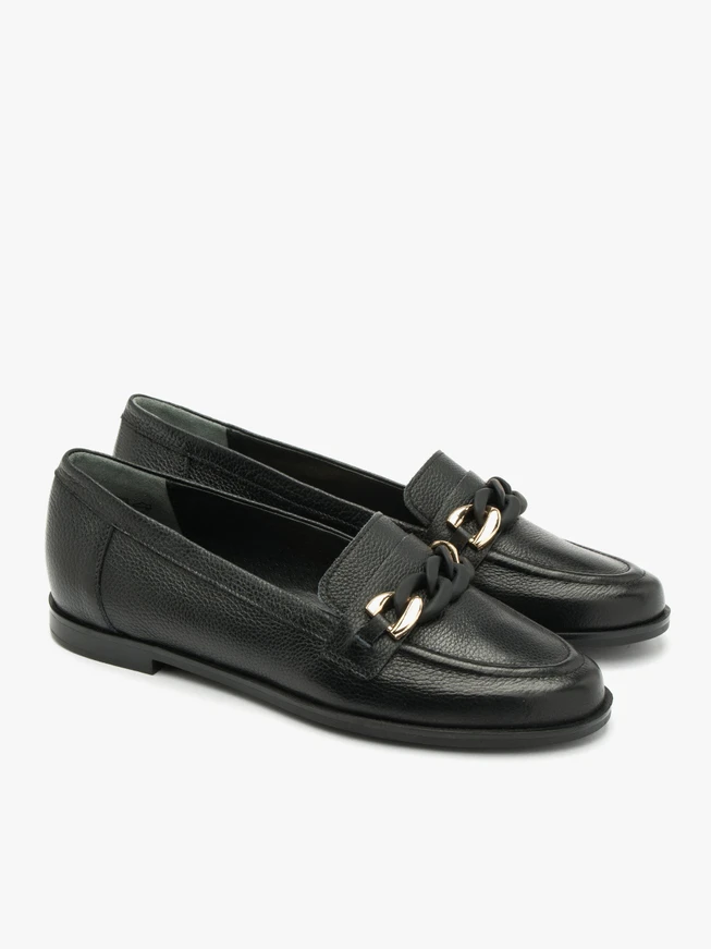 Black loafers with gold-and-black ornament