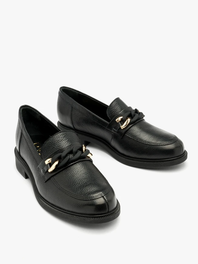 Black loafers with gold-and-black ornament