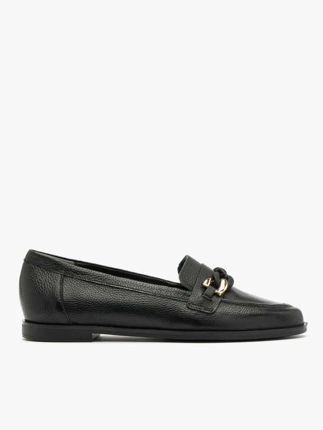 Black loafers with gold-and-black ornament