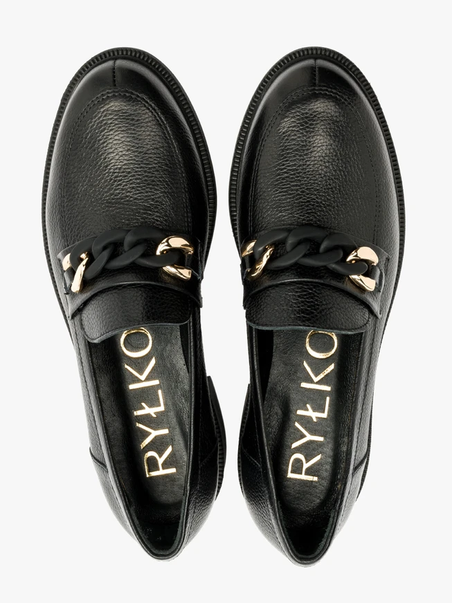 Black loafers with gold-and-black ornament