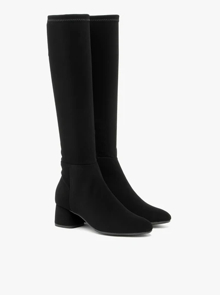 Stretch knee boots with narrow shaft and low heel