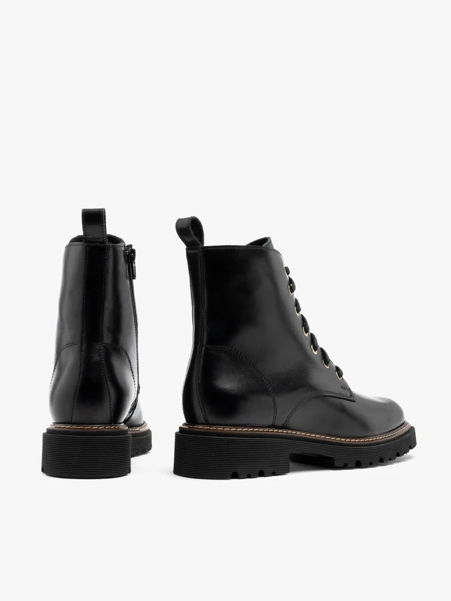Black women’s boots with gold eyelets