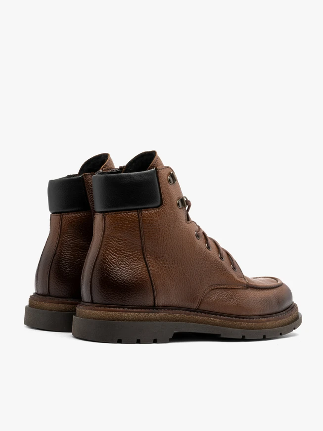 Brown men’s boots with decorative stitching on instep