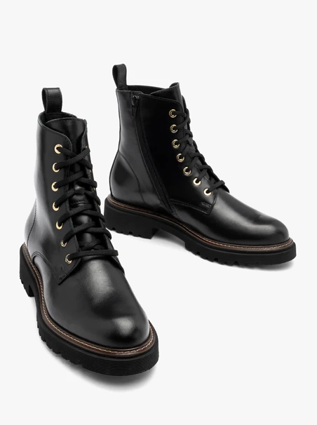 Black women’s boots with gold eyelets