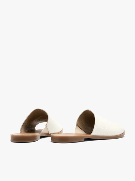 White women’s slides on a flat sole