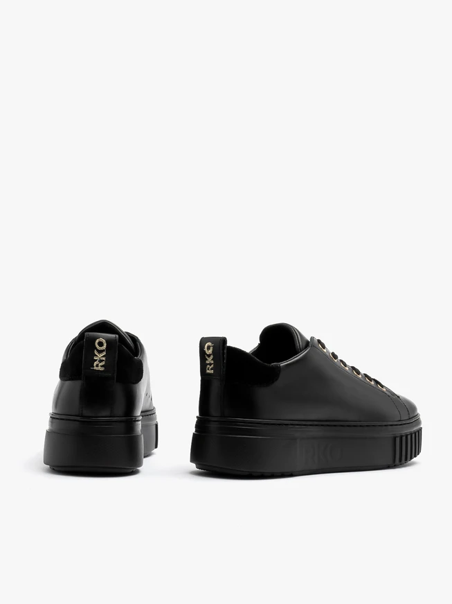 Black sporty shoes with gold details and thick sole