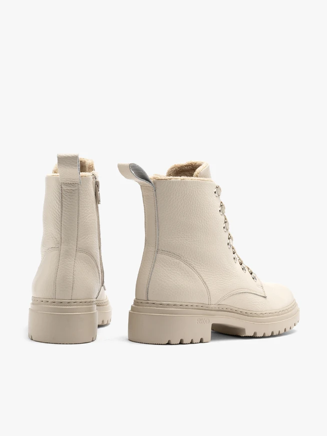 Cream women’s boots with decorative hooks