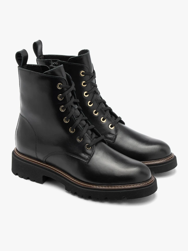 Black women’s boots with gold eyelets
