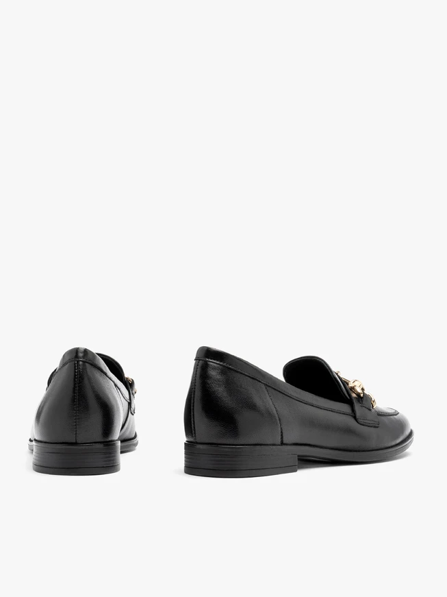 Black loafers with gold ornament