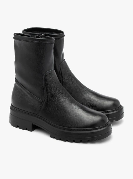 Black stretch ankle boots on a flat sole