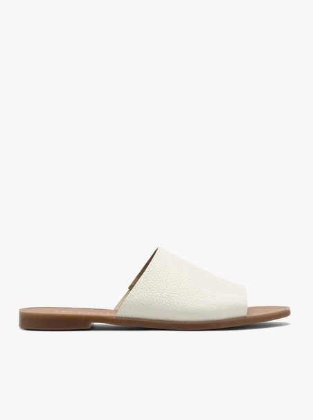 White women’s slides on a flat sole