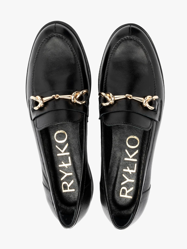 Black loafers with gold ornament