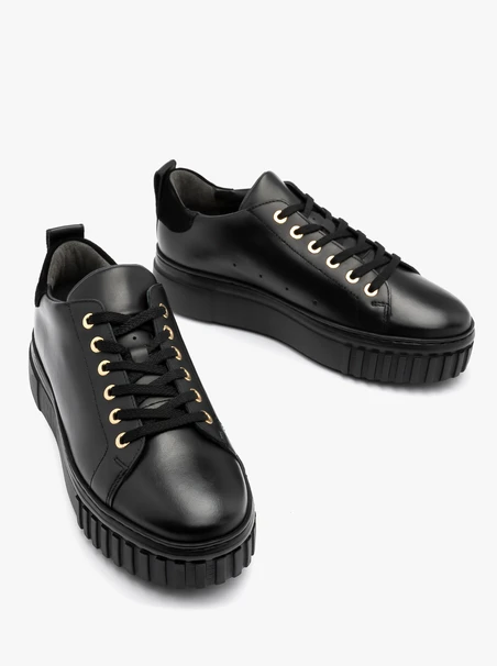 Black sporty shoes with gold details and thick sole
