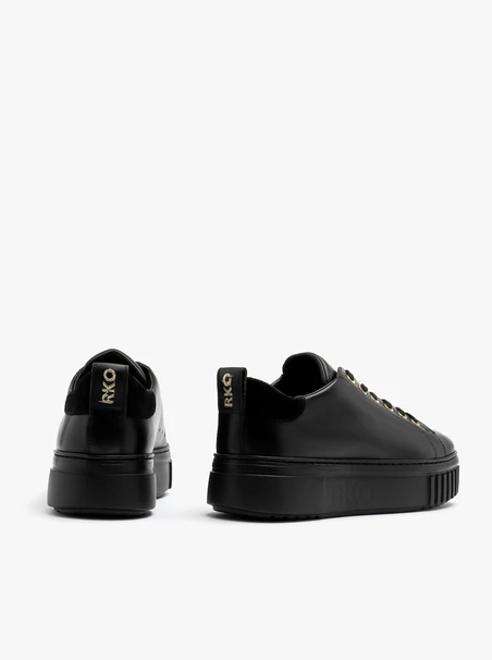 Black sporty shoes with gold details and thick sole