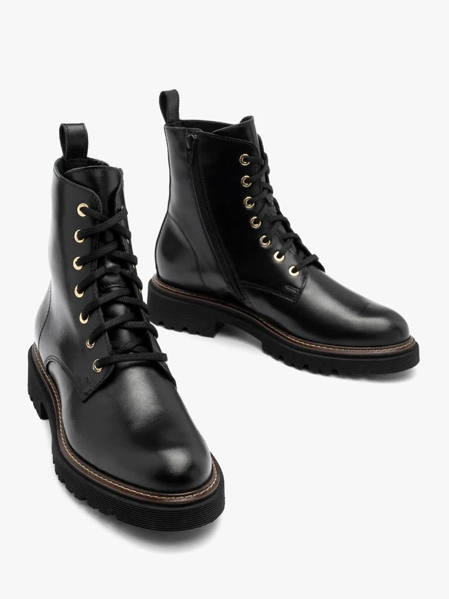 Black women’s boots with gold eyelets