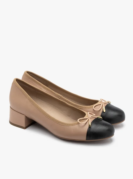 Beige and black pumps with decorative bow