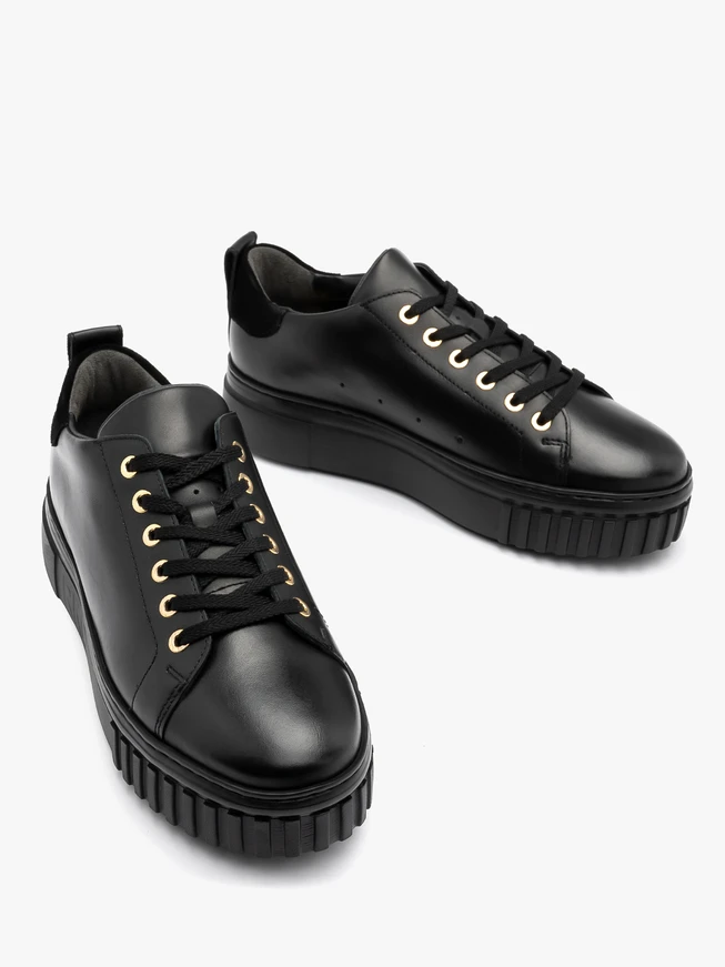 Black sporty shoes with gold details and thick sole