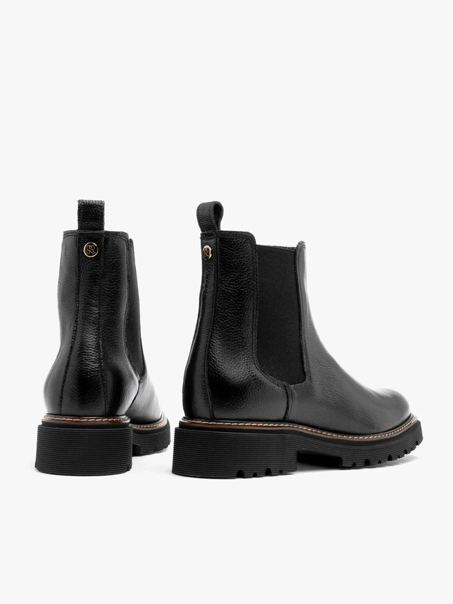 Black Chelsea boots with lug sole and contrast welt