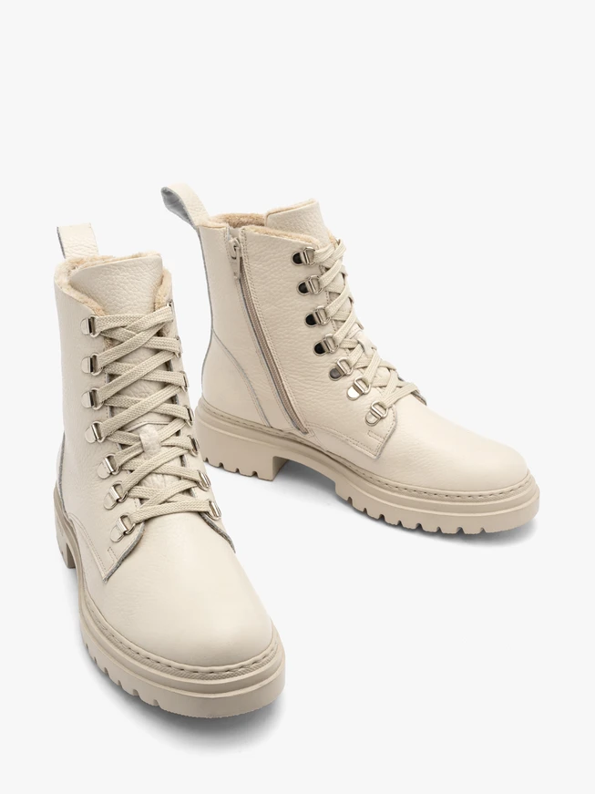 Cream women’s boots with decorative hooks