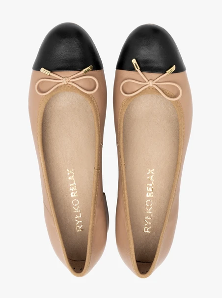 Beige and black pumps with decorative bow