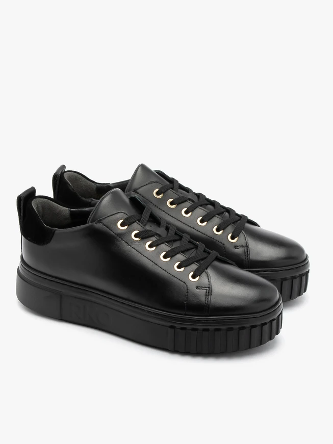Black sporty shoes with gold details and thick sole