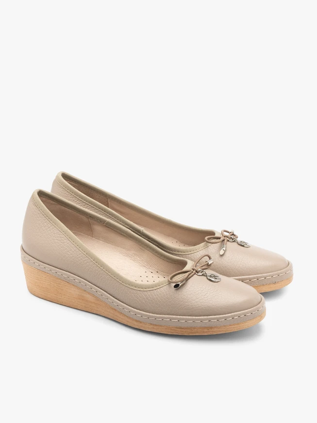 Beige platform pumps with decorative bow