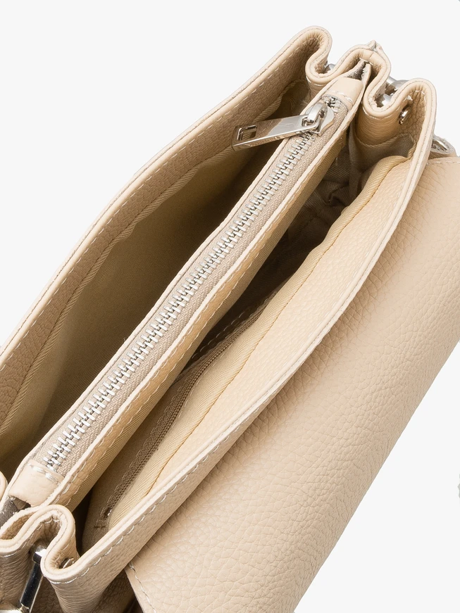 Small beige handbag with decorative handle
