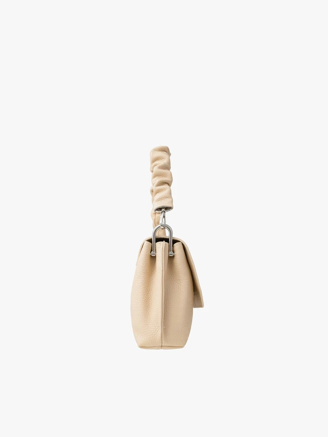 Small beige handbag with decorative handle