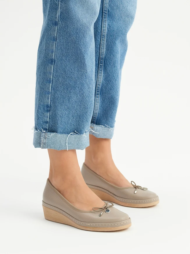 Beige platform pumps with decorative bow
