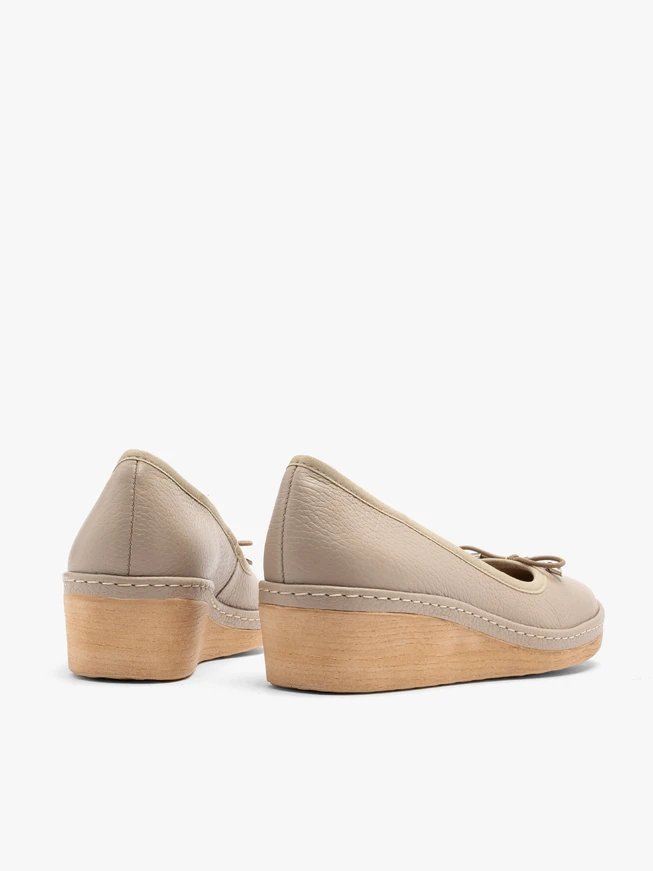 Beige platform pumps with decorative bow