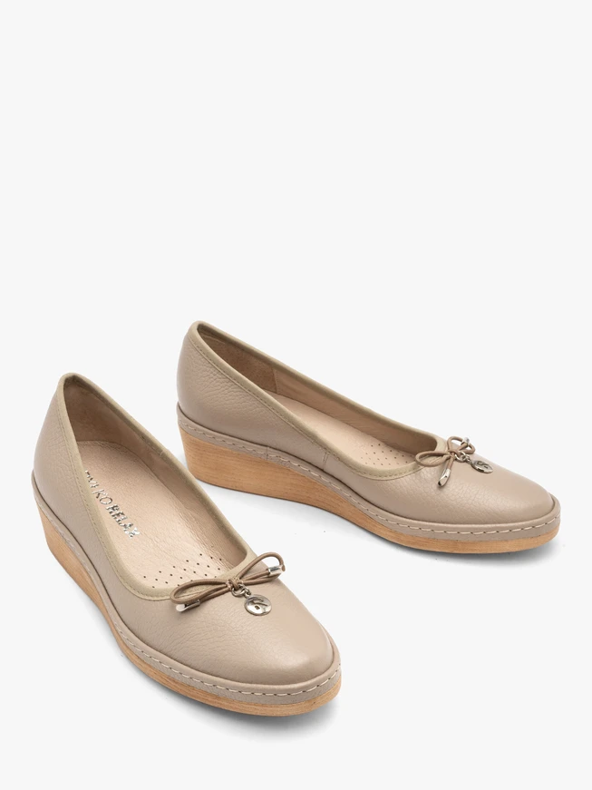 Beige platform pumps with decorative bow