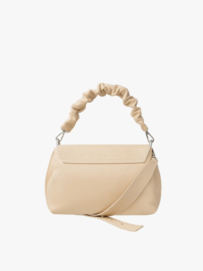 Small beige handbag with decorative handle