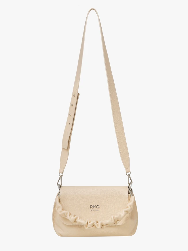 Small beige handbag with decorative handle