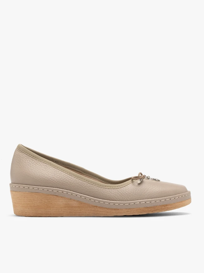 Beige platform pumps with decorative bow