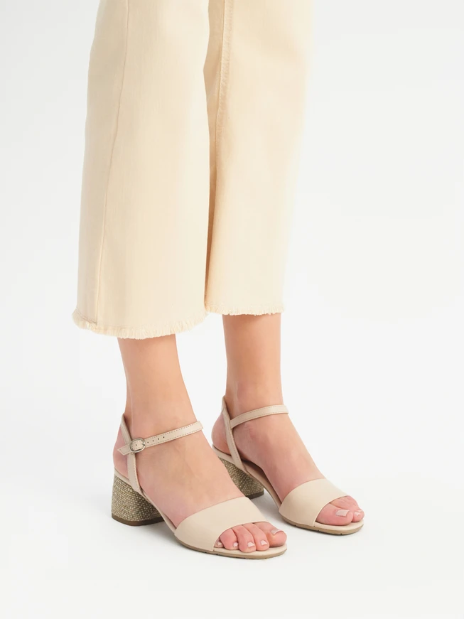Beige sandals with decoratively covered heel