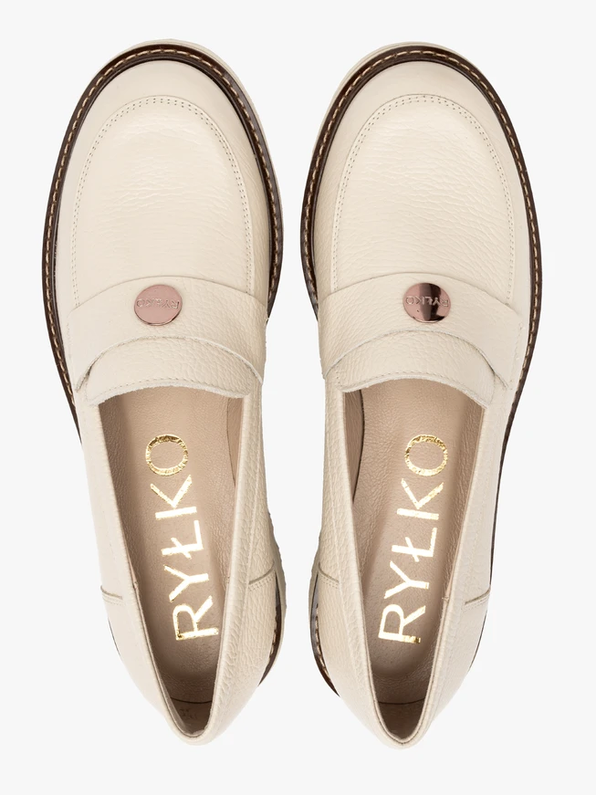 Cream moccasins with a contrasting ottoman on the bottom