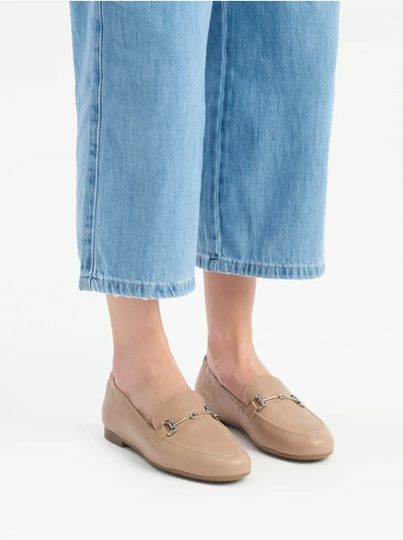 Beige women’s loafers with silver ornament