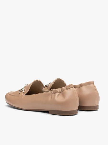Beige women’s loafers with silver ornament