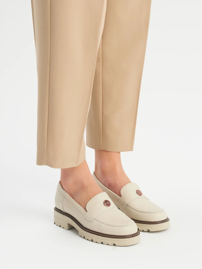 Cream moccasins with a contrasting ottoman on the bottom