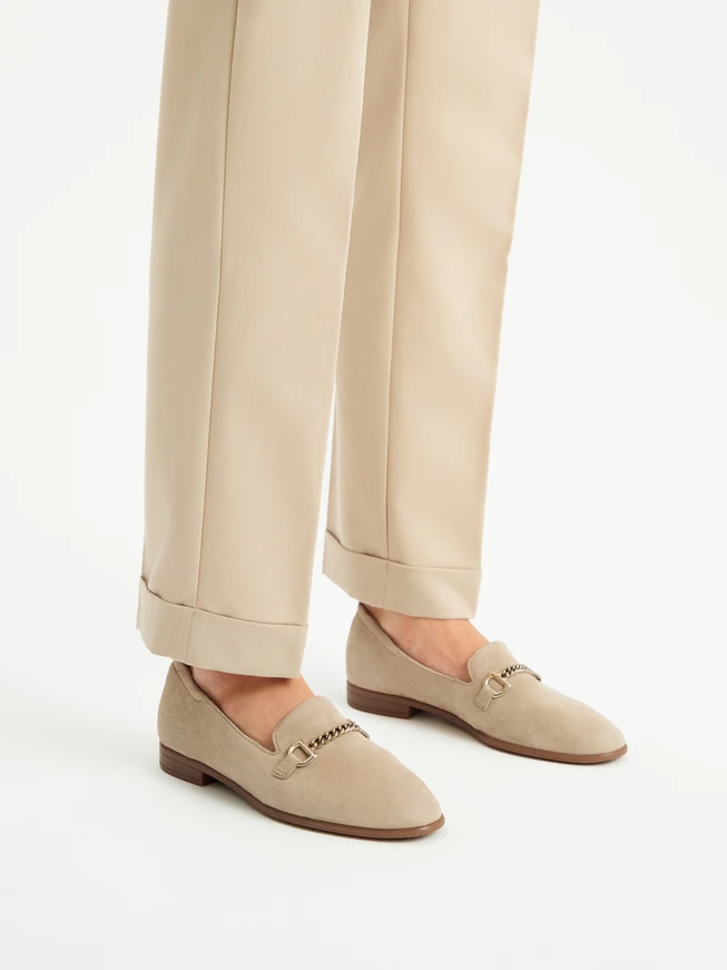 Beige women's moccasins on a flat sole