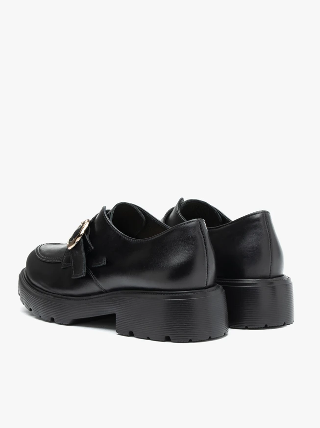 Black leather slip-ons with copper buckle